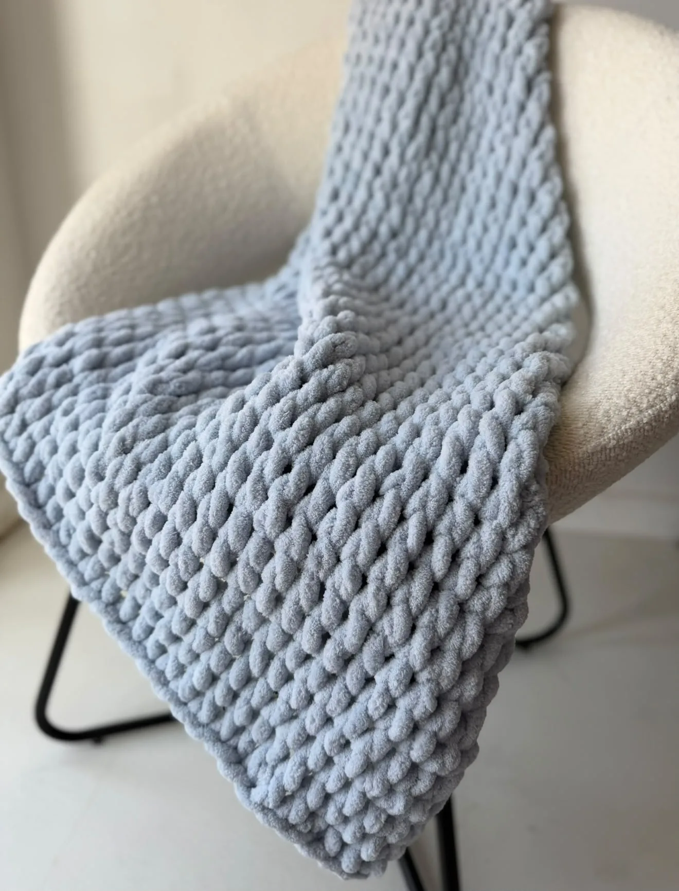 Close view of a soft blue knitted blanket