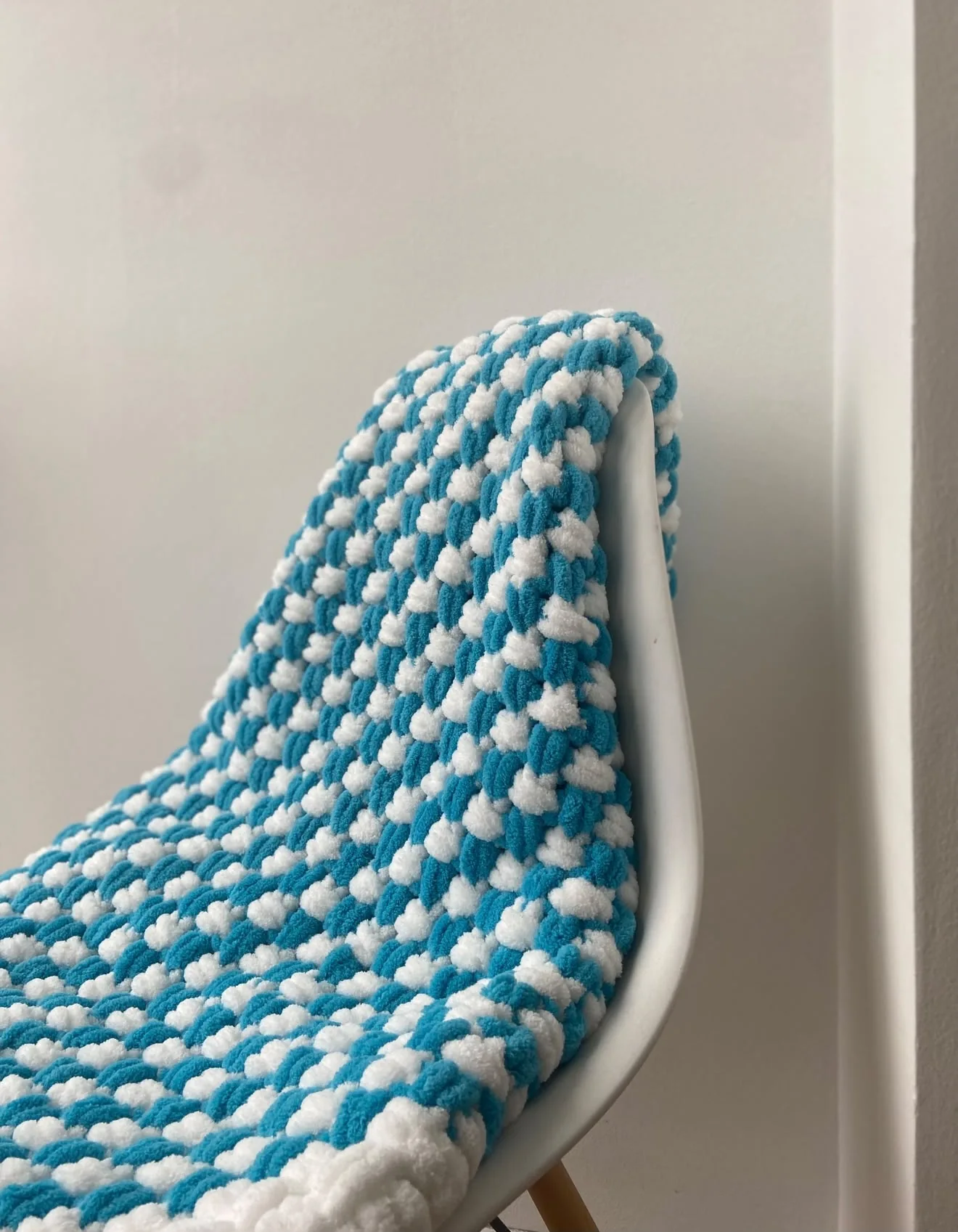 Blue and cream patterned blanket on a chair