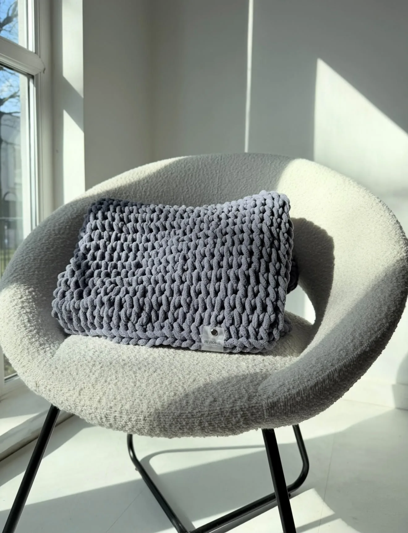 Dark charcoal knitted blanket on a chair