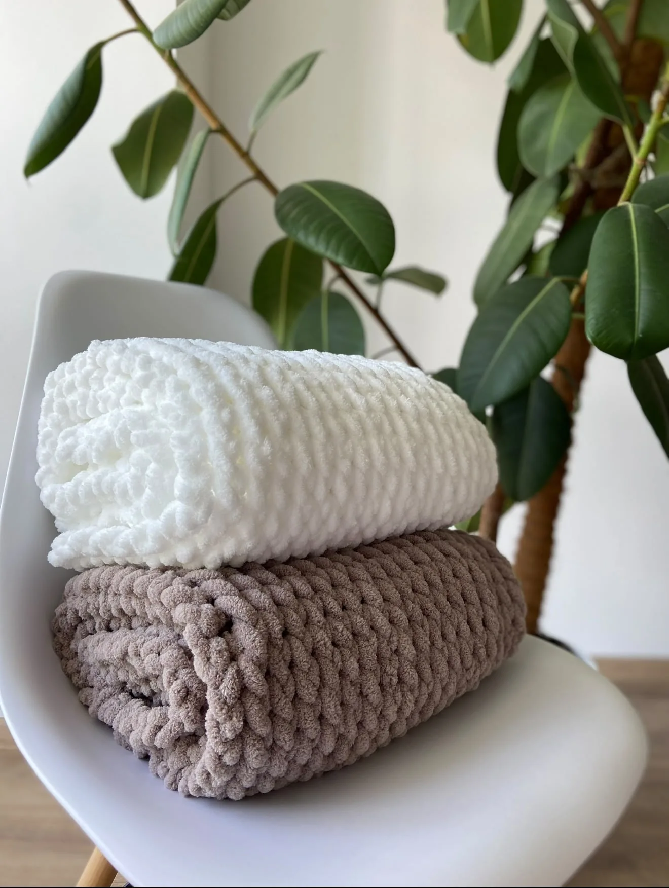 Folded handmade blankets in cream and brown