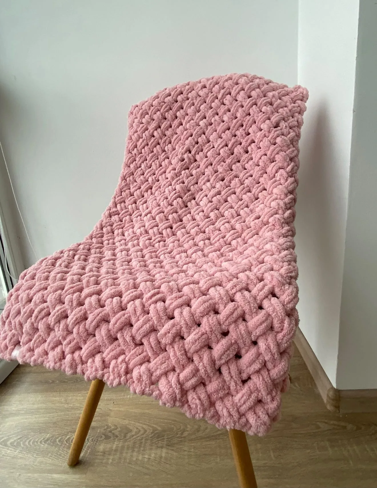Pink knitted blanket with a raised pattern